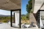 Caseta de piscina con puertas correderas y terraza con pérgola.